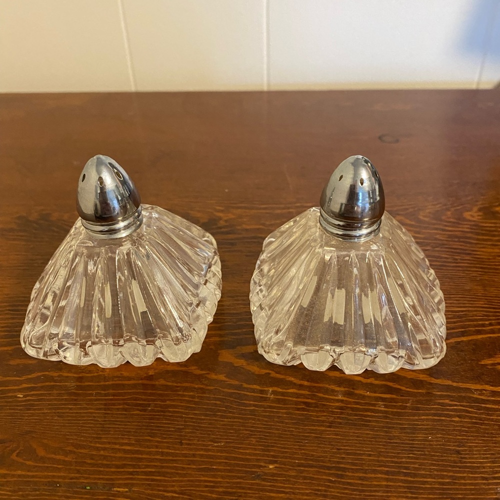 Vintage I. W. Rice glass salt and pepper shakers with metal tops.